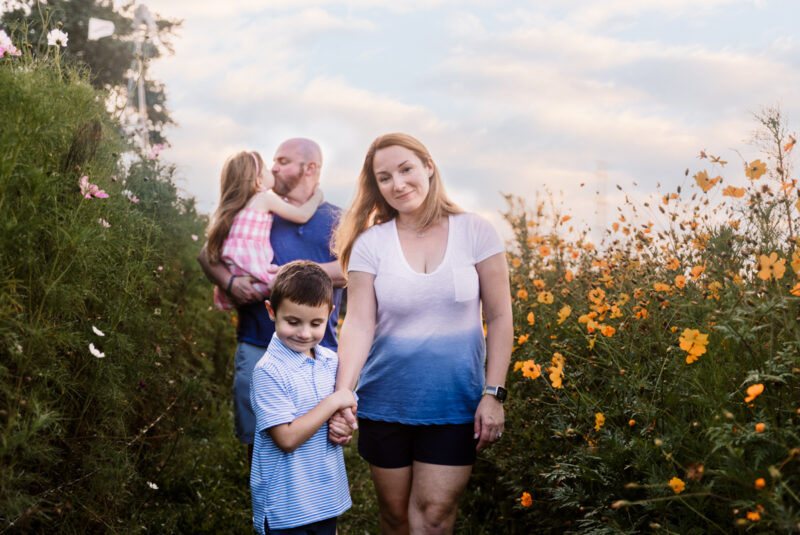 Beautiful family walking through the flower fields at The Wildflower Farm in Monee IL